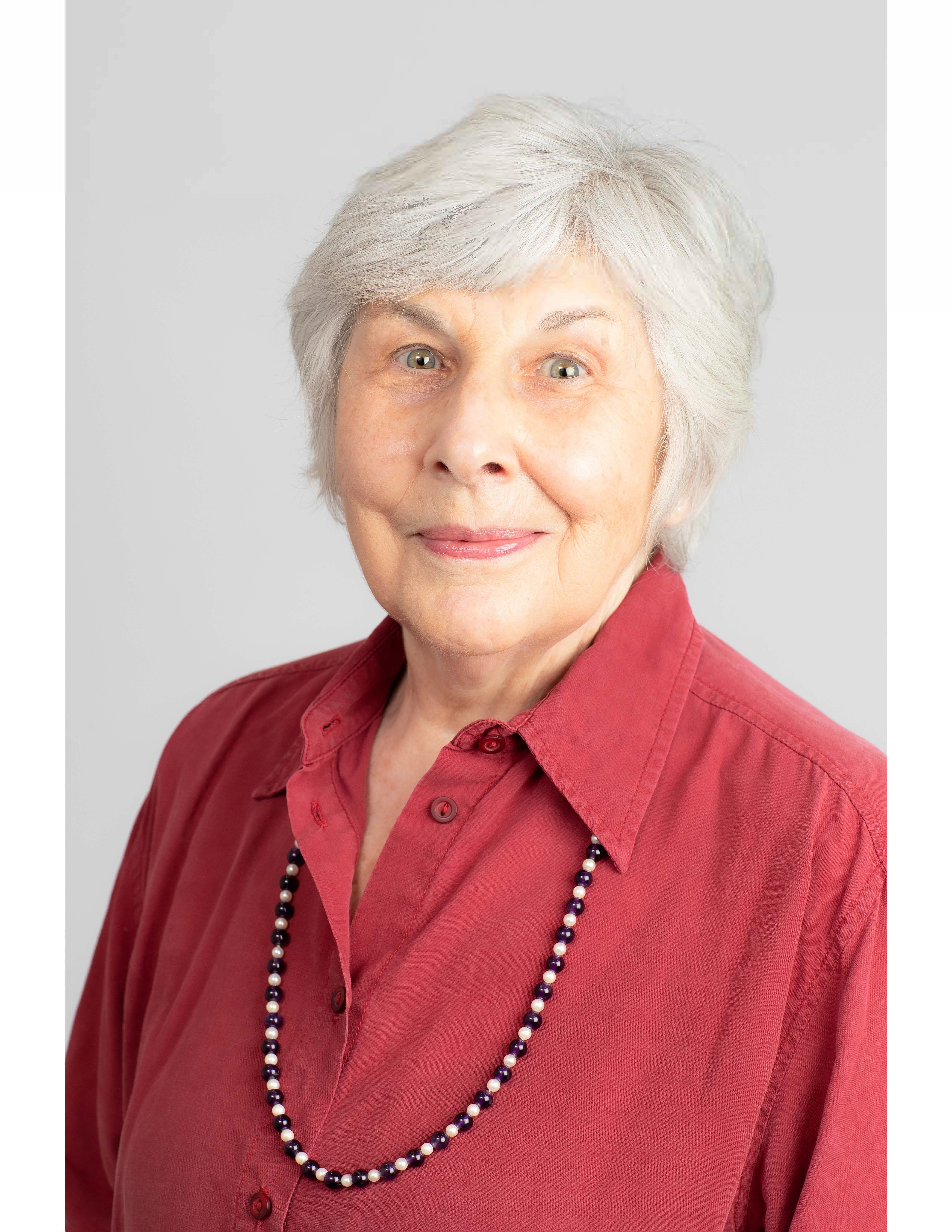 woman in red shirt, smiling, with white background 