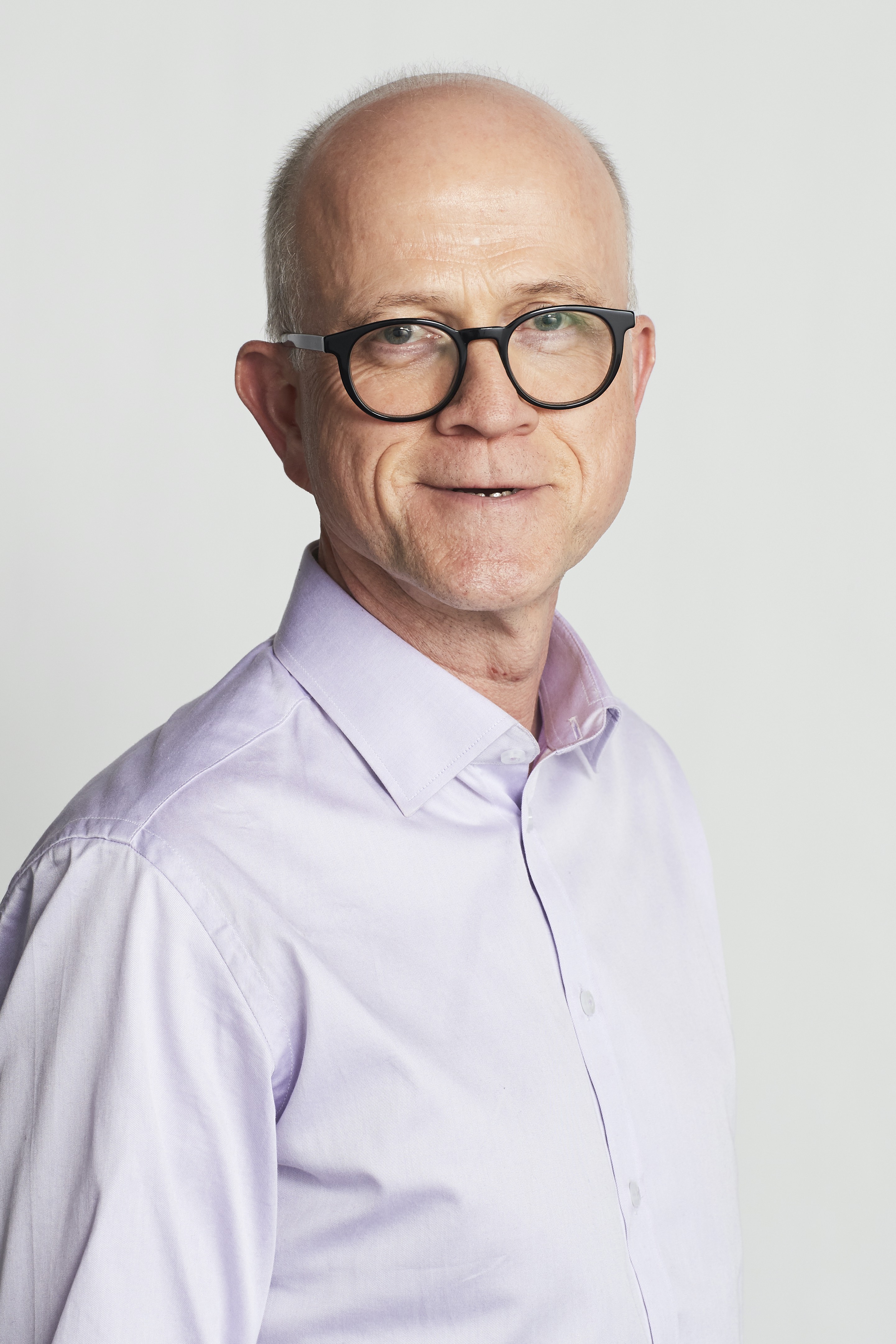 man with purple shirt, brown glasses, white background
