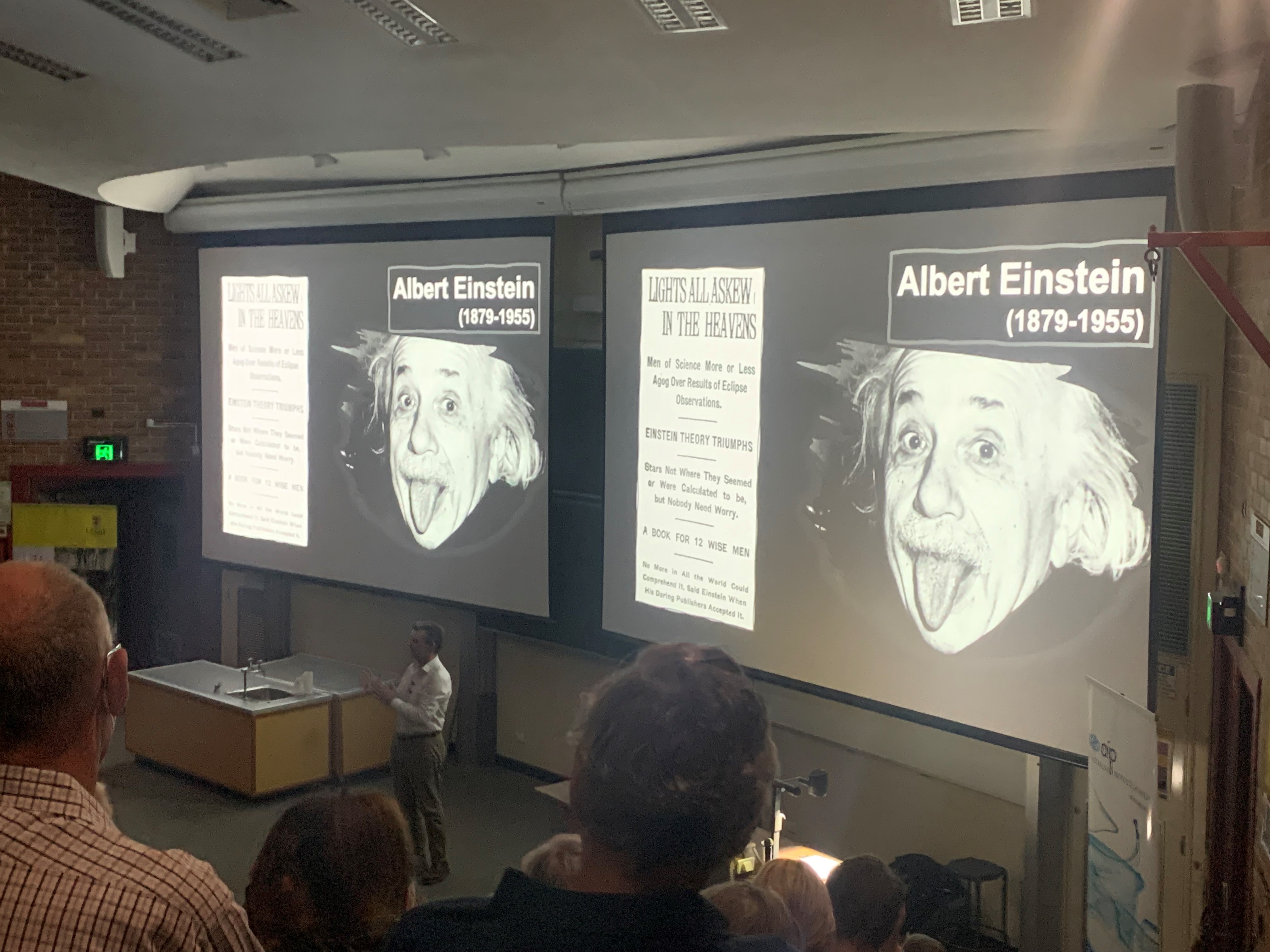 Lecture theatre with Einstein slides on screens