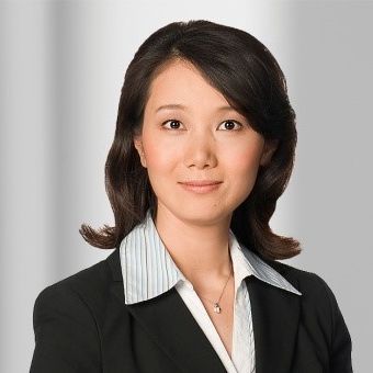 Associate Professor Ge Jiang, wearing a dark suit and a gray shirt