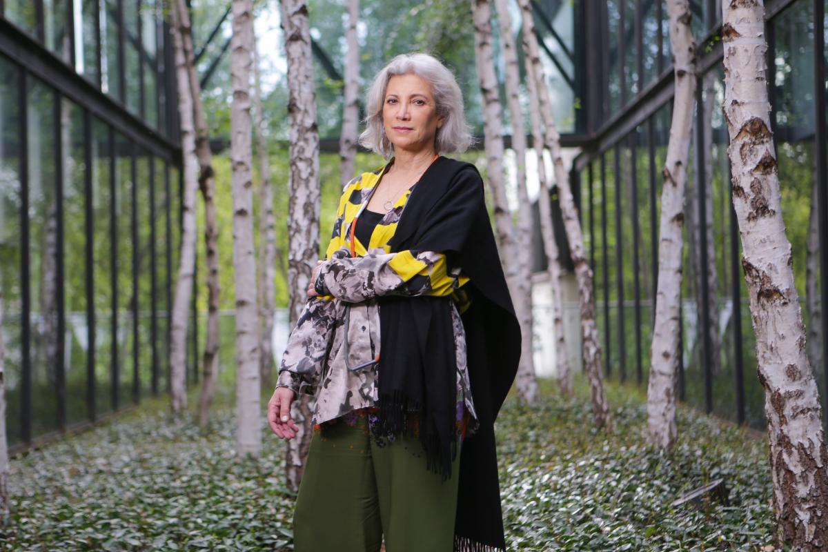 Carme Pinós full length image standing in constructed garden with trees