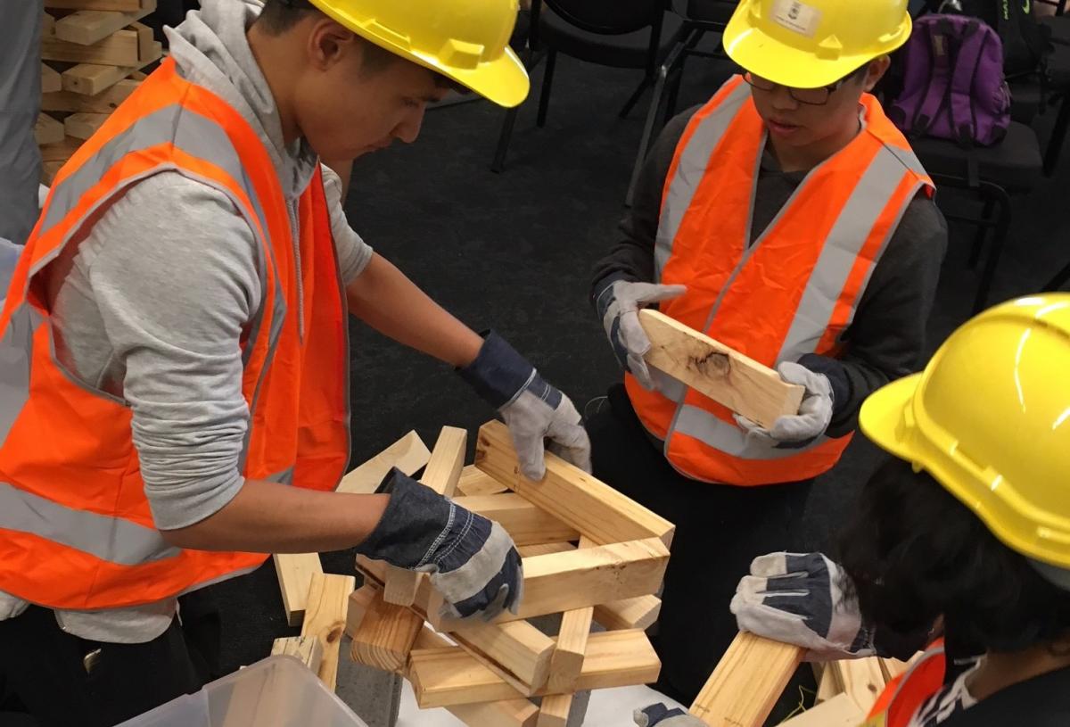 photo of young people constructing wooden model