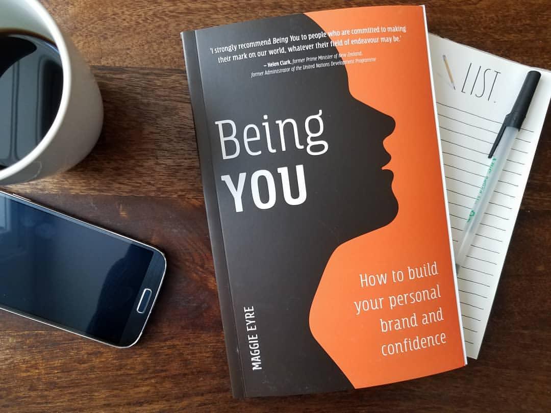 photo of book 'Being you' and a cup of cffee