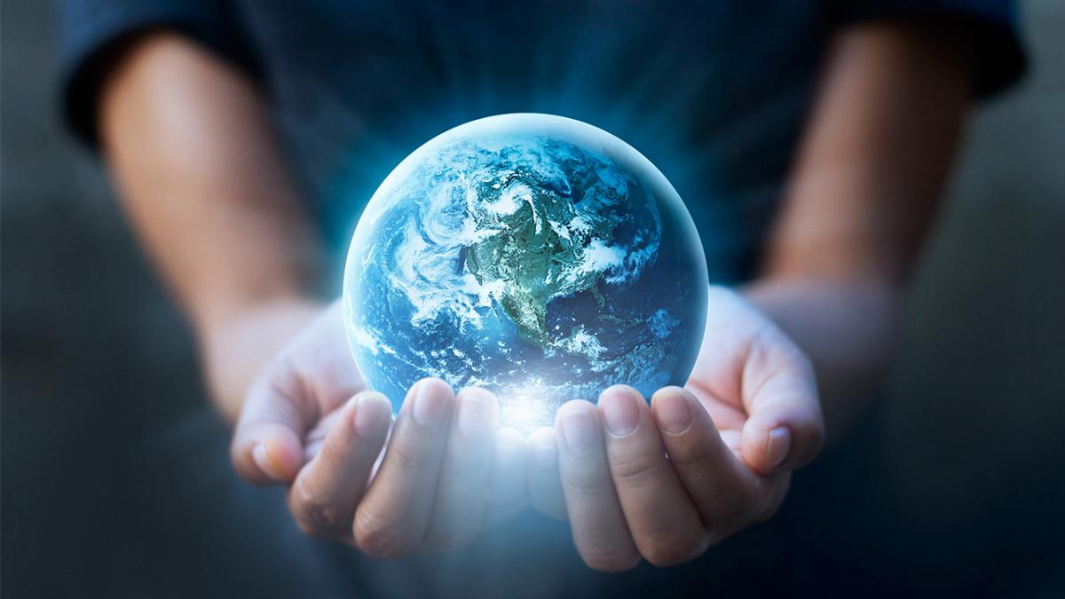 Photograph of a person cupping the world in their hands