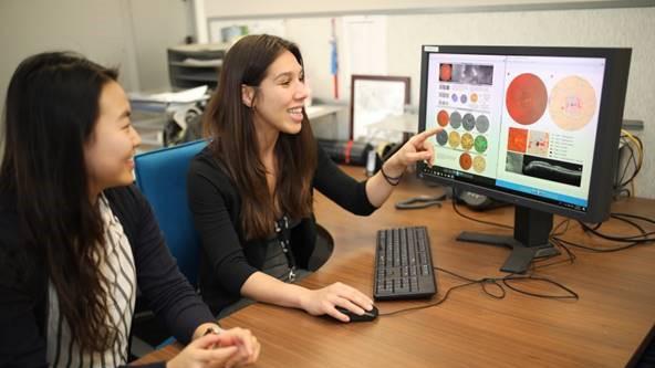 photograph of two women looking at a screen