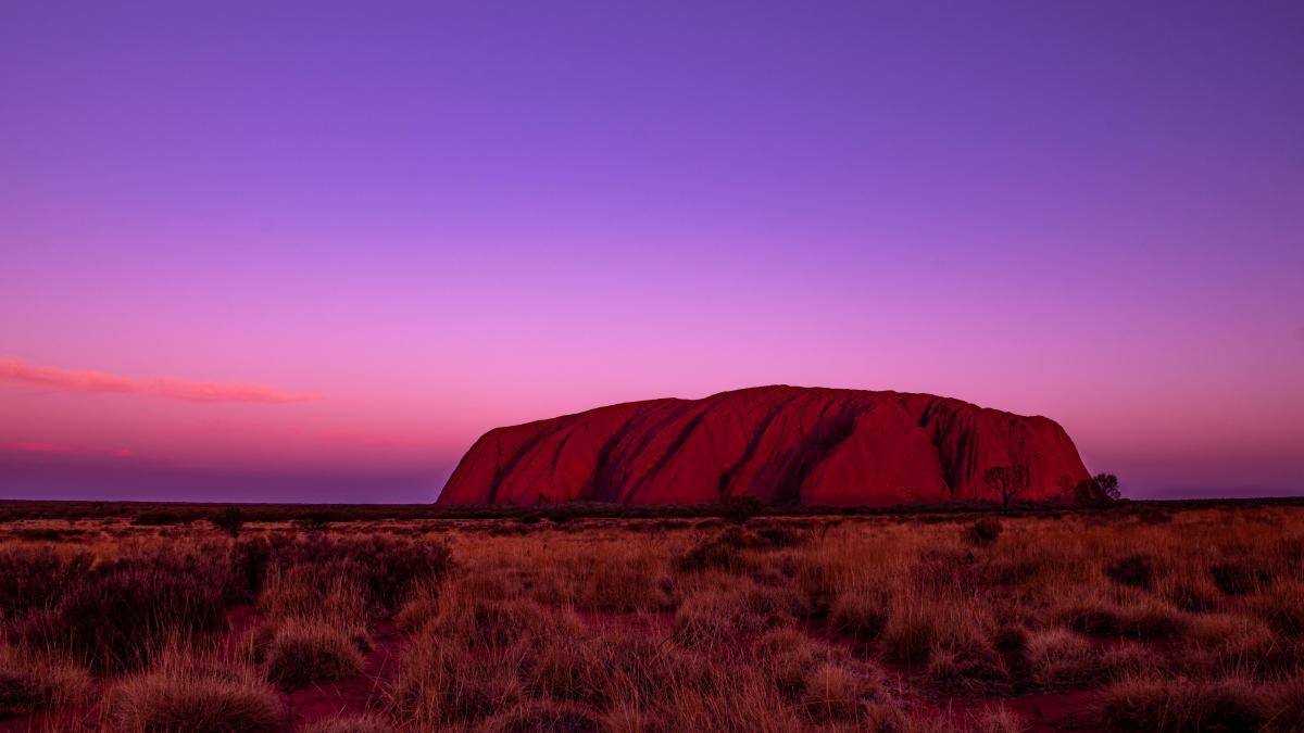 colour photo of Uluru at sunset