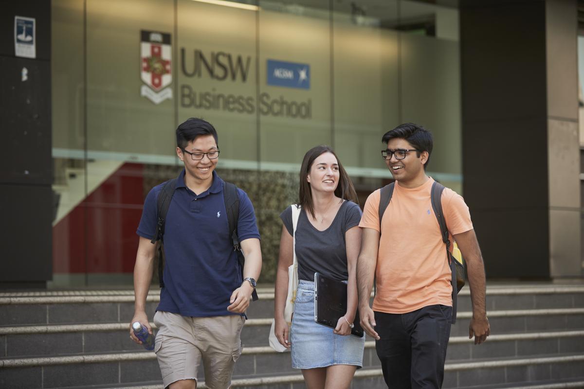 photo of a three young people walking