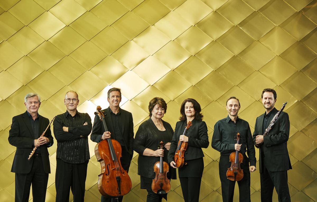 photo of musicians against a gold background