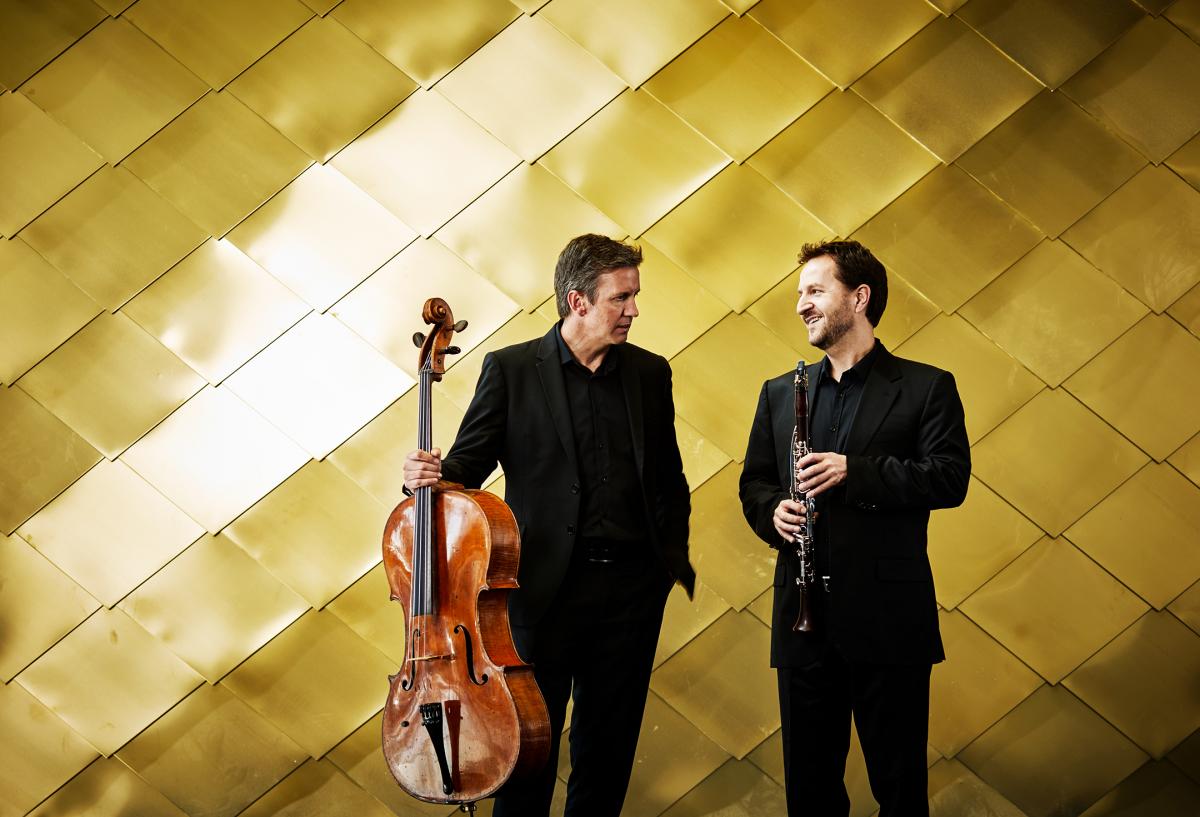 Musicians in front of gold wall