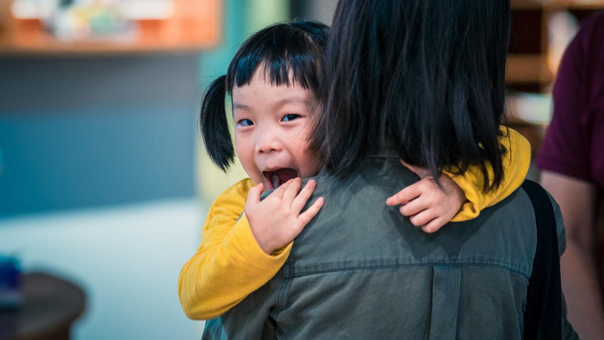 woman carrying girl
