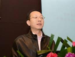 photo of a man speaking a lectern - speaker Shiyong Liu