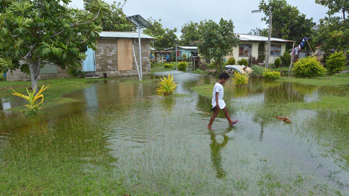 Indigenous Fijian girl walking on flooded land in Fiji (Source: Shutterstock)