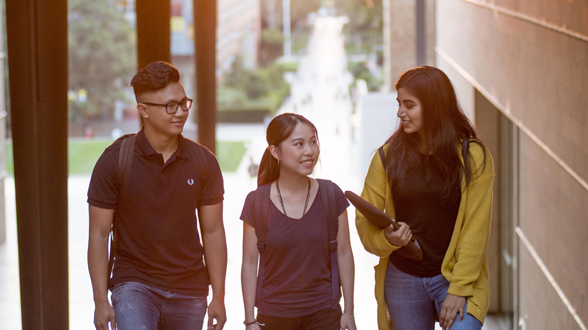 Image of three students talking
