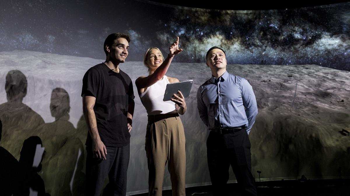 young people looking at something technical