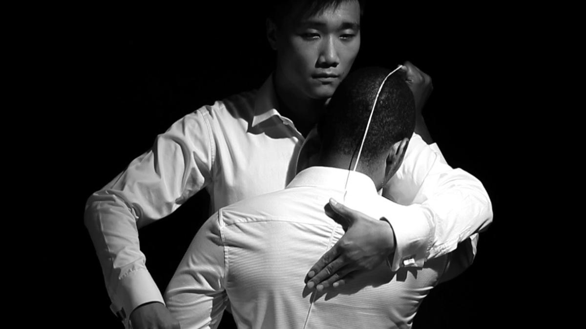 Black and white photo of two men in white shirts