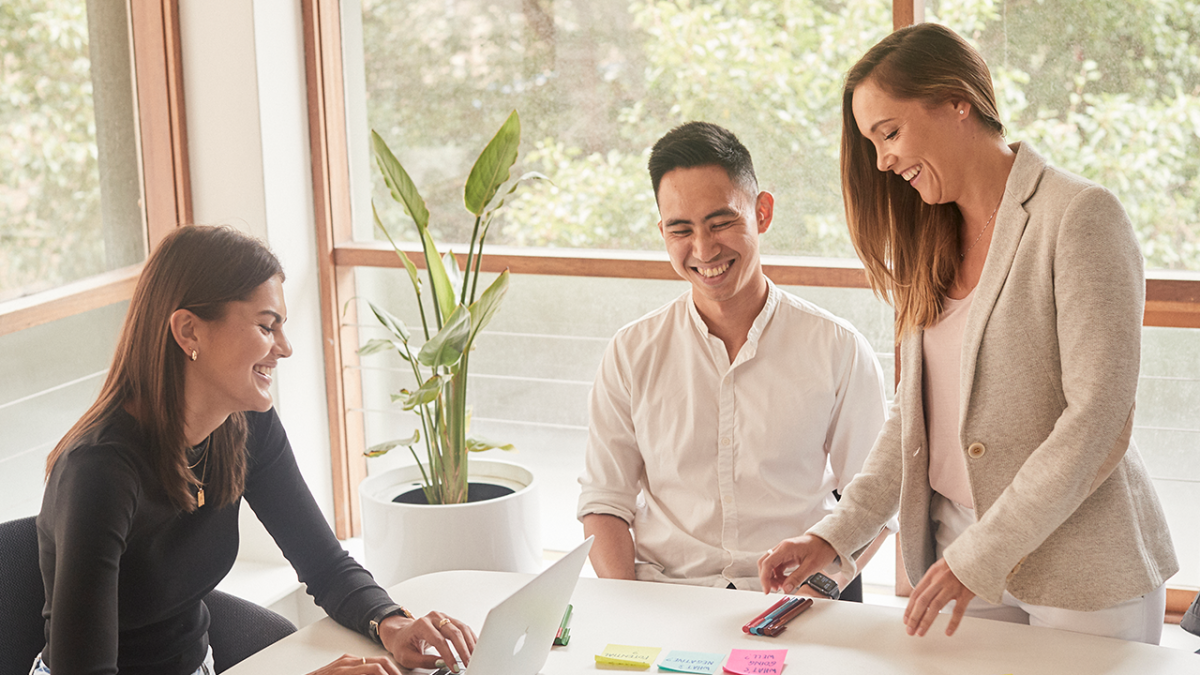 Image of three people in discussion