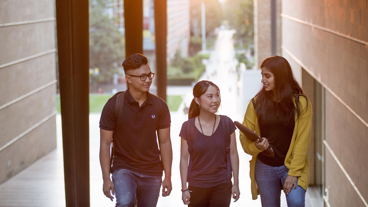 Image of three students talking
