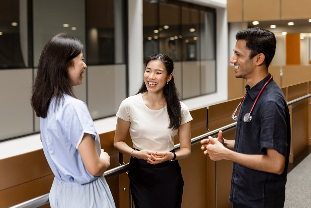 Three international students conversing