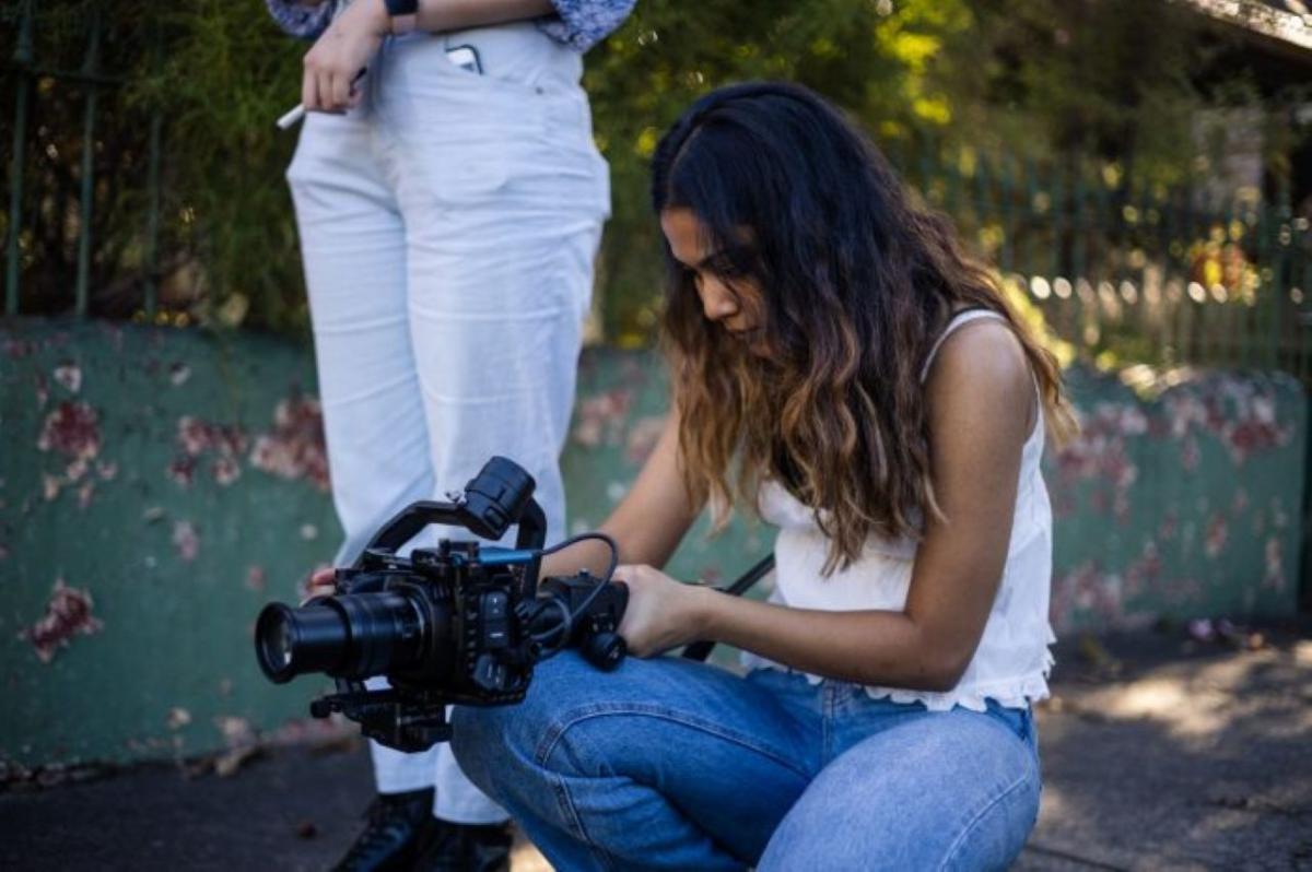 Photo of a girl with a film camera