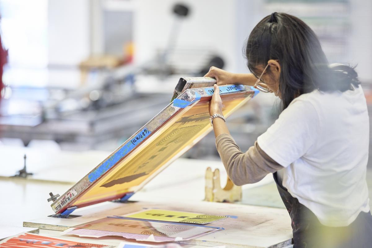 Student doing screenprinting