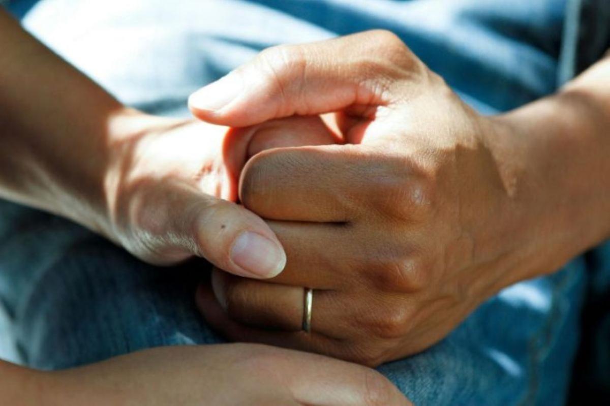 photo of two people holding hands