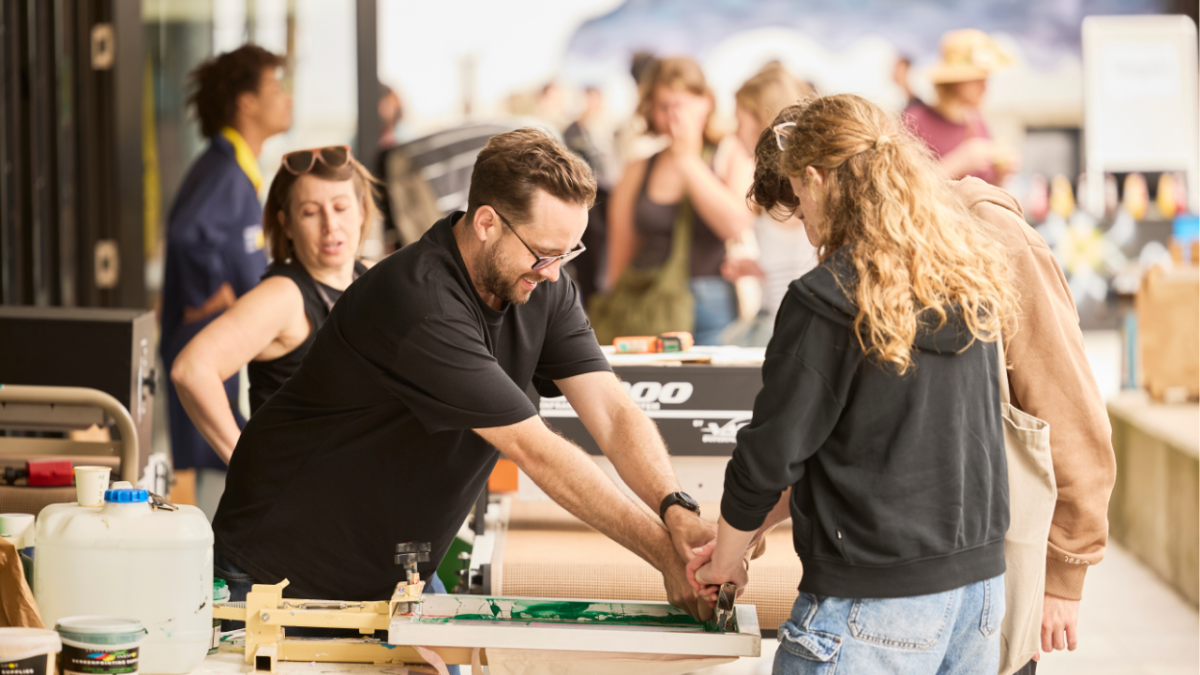 Two people screen printing 